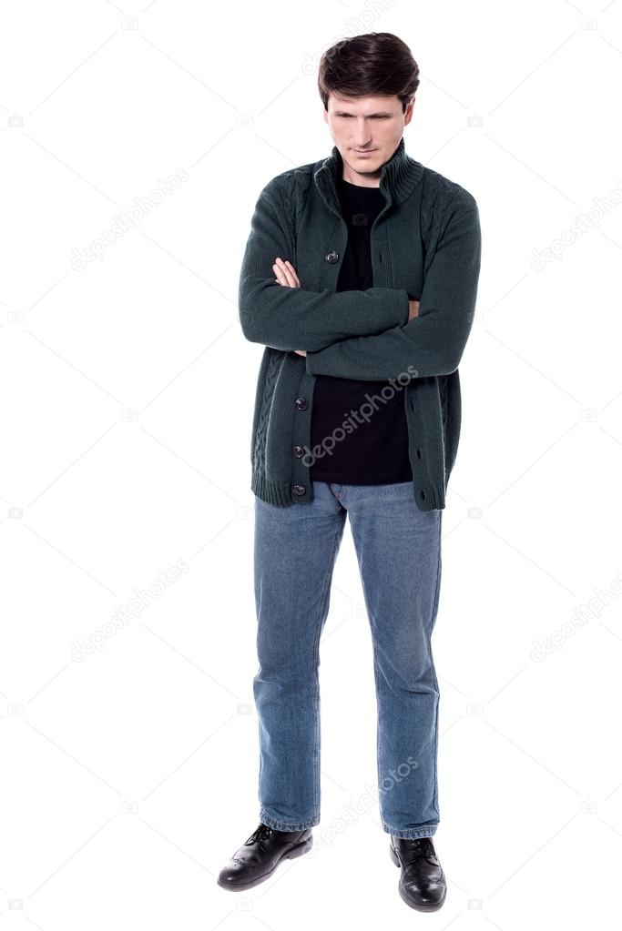 Man looking down with folded arms