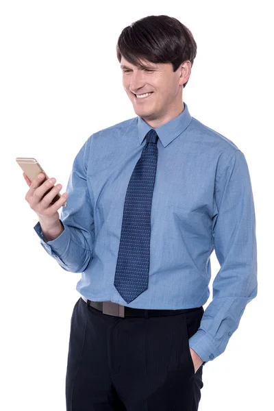 Corporate executive looking at his cellphone — Stock Photo, Image