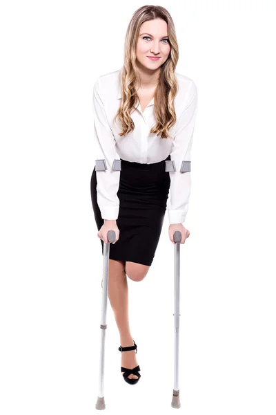 Young business woman with crutches — Stock Photo, Image