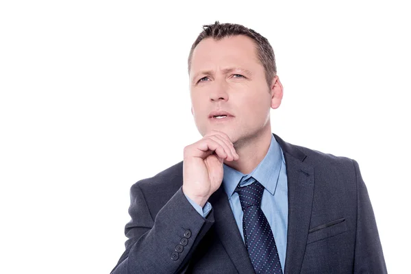 Pensive businessman with hand on chin — Stock Photo, Image