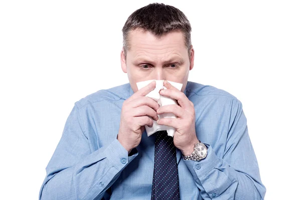 Sick businessman blowing his nose — Stock Photo, Image