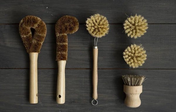 Set of brushes for eco-cleaning the home, washing dishes and surfaces without chemicals and plastic. Zero waste kitchen cleaning concept. Eco friendly natural cleaning bamboo dish brushes.