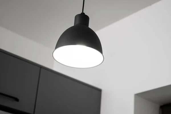 Industrial black look pendant lamps in a kitchen interior. Modern loft interior design.