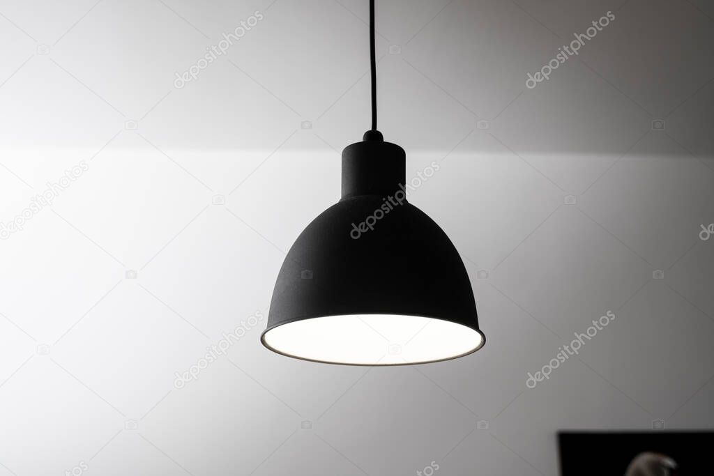 Industrial black look pendant lamps in a kitchen interior. Modern loft interior design.