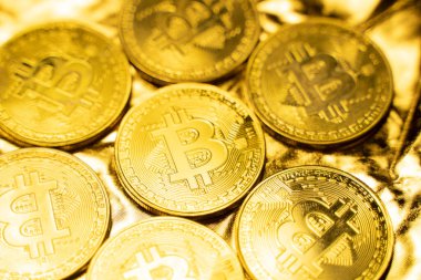 Altın zemin üzerinde altın bitcoin sikkeler. Kripto para değişimi ticareti. Kripto para birimi borsa konsepti. Sanal para konsepti. Madencilik ya da engelleme teknolojisi. İş konsepti.