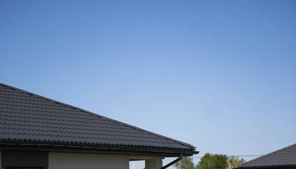Коричневий металевий профіль даху, встановлений на сучасному будинку. Дах рифленого аркуша. Профіль металевого профілю хвилястий. Сучасний дах виготовлений з металу. Металевий дах. — стокове фото