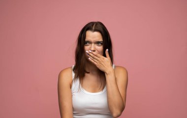 Stüdyoda poz verirken şaşkınlık ya da ani tepki gösteren ağzı açık bir kadın model..