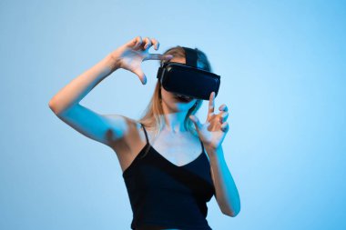 Kadın mühendis, sanal bir çevreyi iki elini de kullanarak keşfediyor. Yenilik kavramı, yüksek teknoloji, ilgi çekici deneyim, mühendislik çözümleri ve dijital ürün geliştirme.