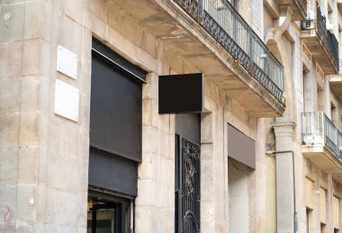 Barcelona 'da eski bir geleneksel bina cephesinde asılı boş siyah kare tabela, bir sokak ortamında taklit tasarımlar ve ticari markalaşma için kopya alanı sunuyor