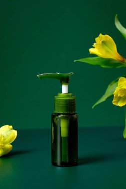 Yeşil, temiz, krem losyonlu bir pompa şişesi ve yeşil arka planda bir çiçek. Doğal organik kozmetik paket tasarımı.