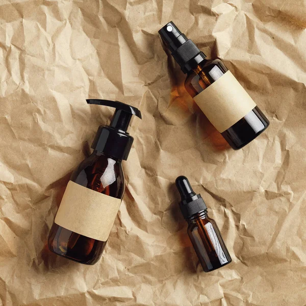 Set Amber Glass Cosmetic Bottles Kraft Paper Top View Flat — Stock Photo, Image