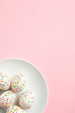 Pembe arka planda renkli Paskalya yumurtaları. Düz konum, üst görünüm, kopyalama alanı.