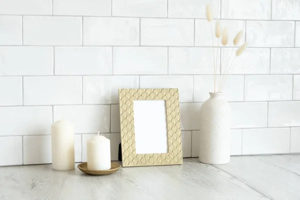 Golden picture frame mockup and home decor on table in living room interior. Scandinavian, nordic style.