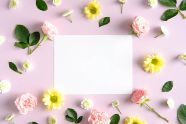 Blank greeting card mockup and flowers on pink background. Happy Mother's Day, Birthday, anniversary concept.