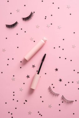 Mascara with false eyelashes on color background. Flat lay, top view.