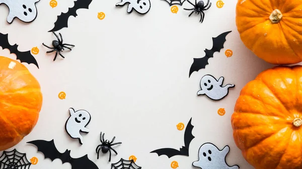 Tatlı cadılar bayramı bembeyaz arka planda balkabakları, hayaletler, yarasalar, örümcekler ve ağ ile bezenmiş. Düz konum, üst görünüm, kopyalama alanı. Mutlu Cadılar Bayramı afişi tasarımı.