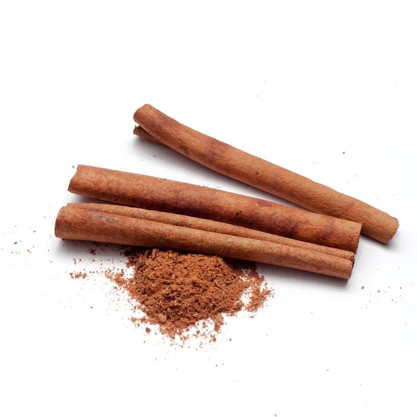 Cinnamon sticks and powder on white background — Stock Photo, Image
