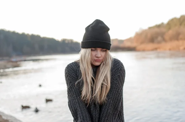 温柔的女孩，在一件暖和的毛衣和帽子在阳光明媚的冬日外摆姿势 — 图库照片