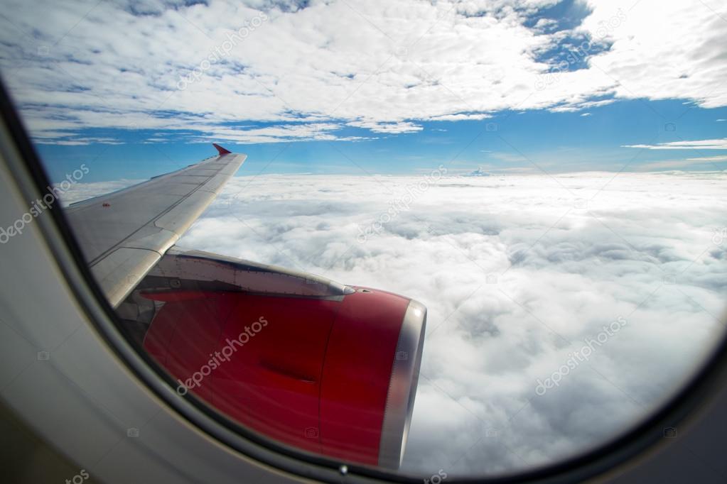 Clouds and sky as seen through window of an aircraft