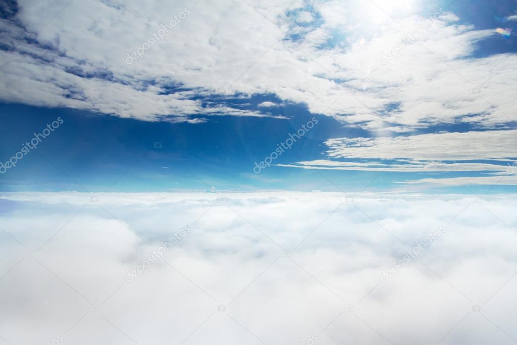 Clouds and sky as seen through window of an aircraft