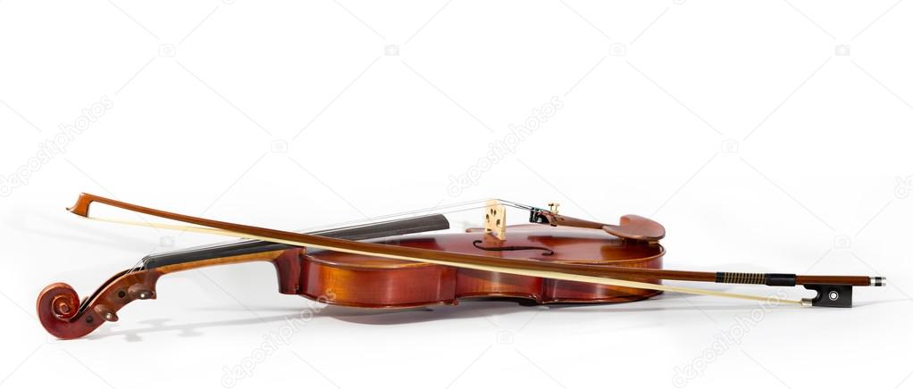 Close up of a violin and bow on book music background