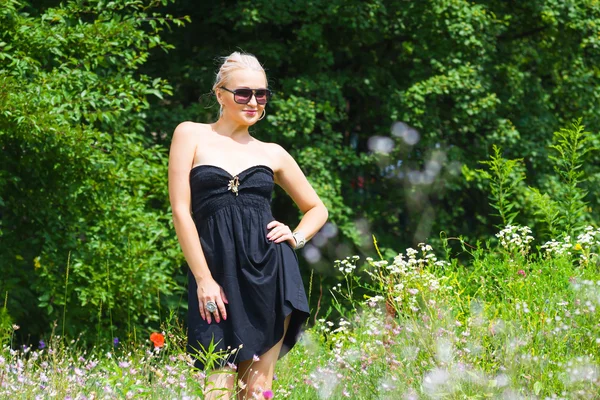 The beautiful blonde in a black dress — Stock Photo, Image