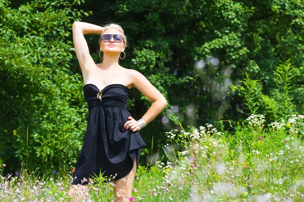 The beautiful blonde in a black dress — Stock Photo, Image