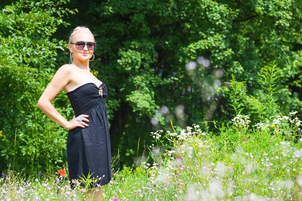 The beautiful blonde in a black dress — Stock Photo, Image