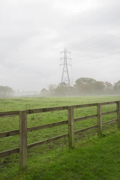 Transmission tower, pylon, in the foggy countryside — Stock Photo, Image