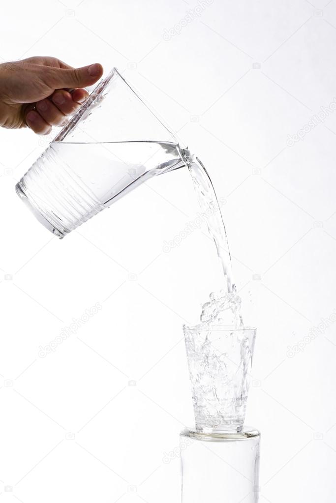 Poured water from a jug into a glass