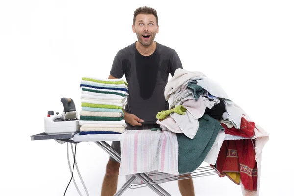 Desperate man behind an ironing board — Stock Photo, Image