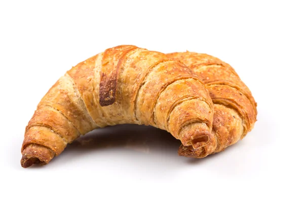 Croissant över vit bakgrund — Stockfoto