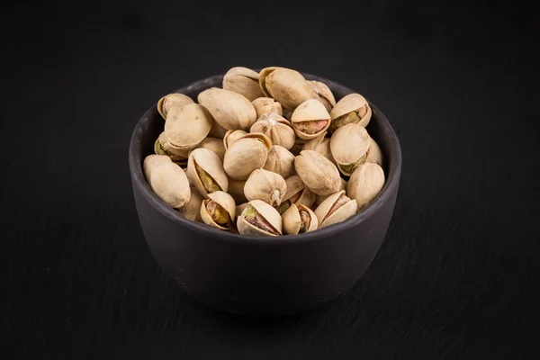 Pistachio nuts in bowl — Stock Photo, Image