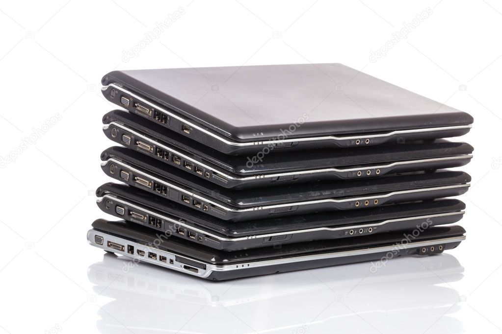 stack of old laptops awaiting repair