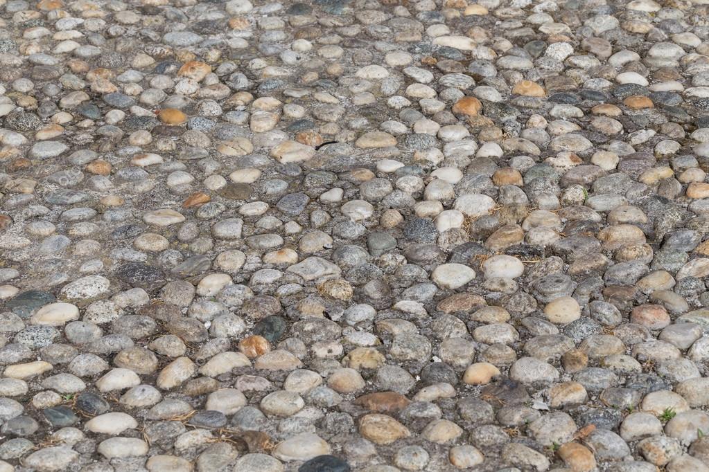 Round Stones In The Ground Stock Photo Romantsubin 106848332 Round Stones In The Ground Texture Of Cobblestones Park Paved Road For Pedestrians Paving Background Photo By Romantsubin