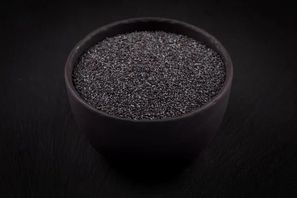 Poppy seeds in a stone bowl — Stock Photo, Image