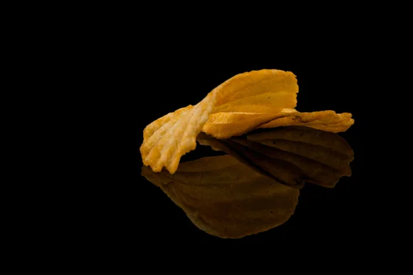 Potato chip on black — Stock Photo, Image