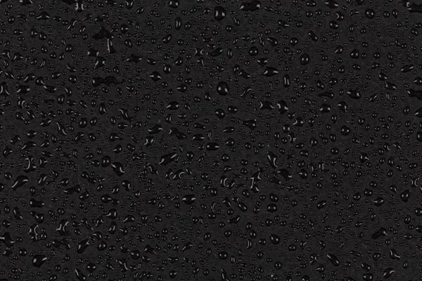 Gotas de água na superfície de pedra escura — Fotografia de Stock