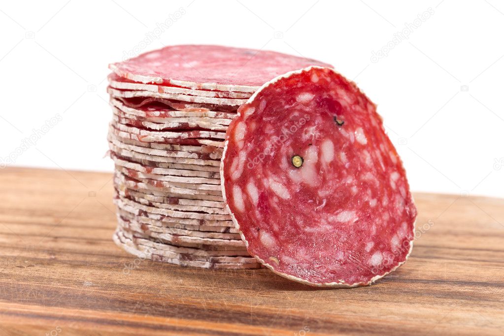 Slices of salami on wooden board