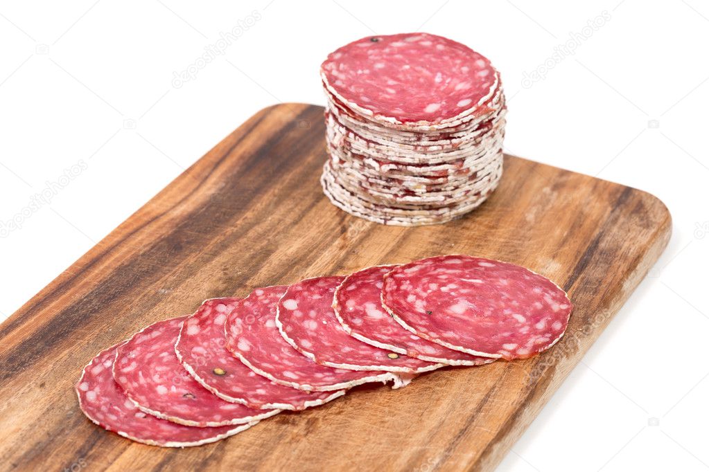Slices of salami on wooden board
