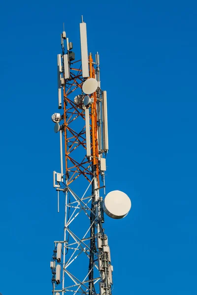 Communications tower with antennas on blue sky — Stock Photo, Image