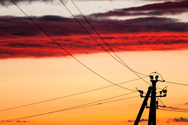 Elektrické linie proti barevné nebe při západu slunce — Stock fotografie