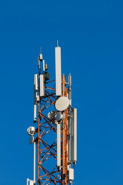 Communications tower with antennas on blue sky — Stock Photo, Image