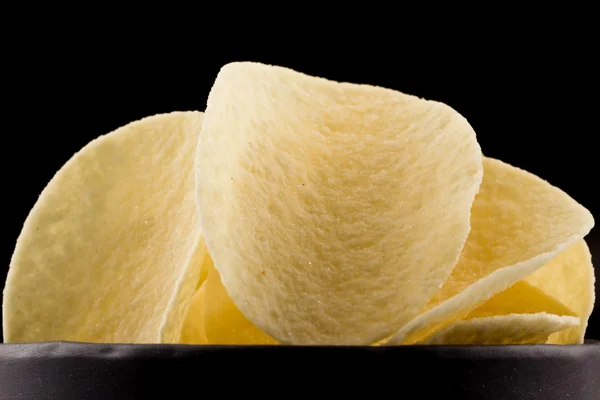 Potato chips on a black background — Stock Photo, Image