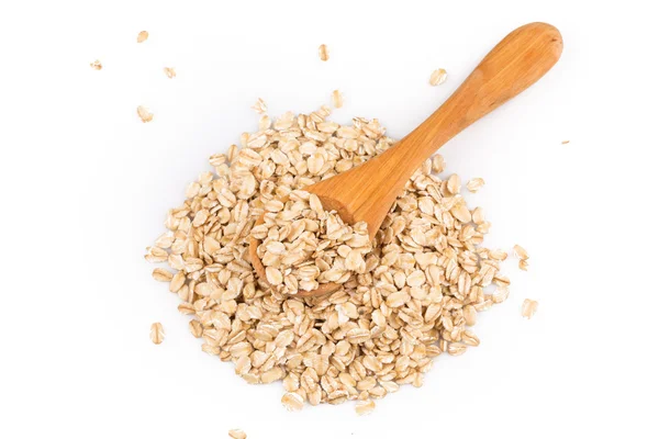 Oatmeal flakes in wooden spoon — Stock Photo, Image