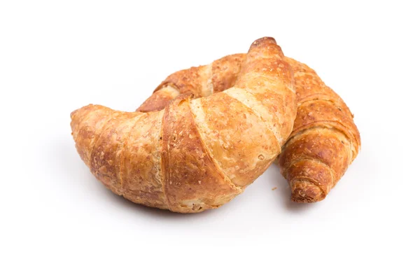 Croissant över vit bakgrund — Stockfoto