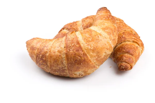 Croissant över vit bakgrund — Stockfoto