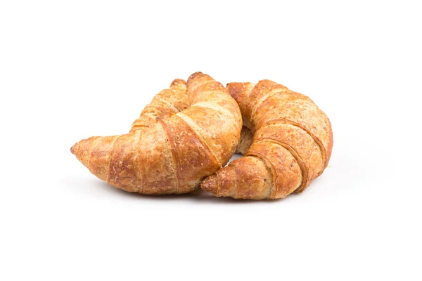 Croissant över vit bakgrund — Stockfoto