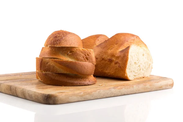 Sliced bread on a wooden chopping board — Stock Photo, Image