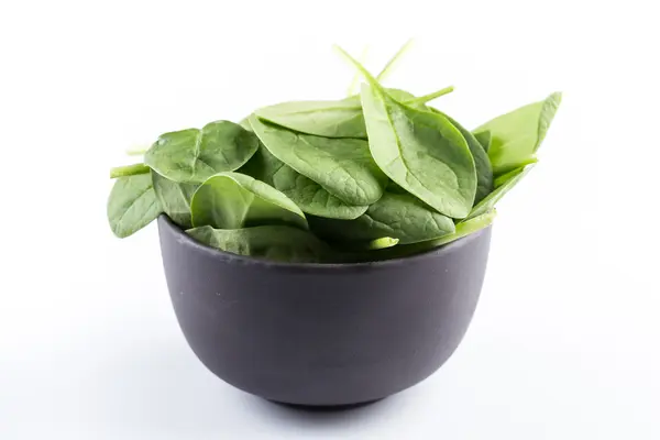 Green spinach on a white background — Stock Photo, Image